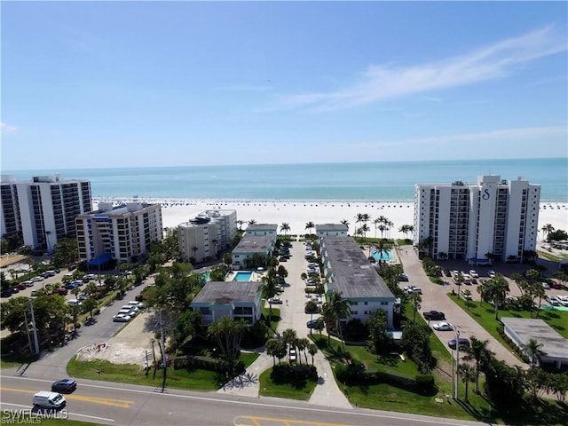 drone / aerial view featuring a view of the beach and a water view