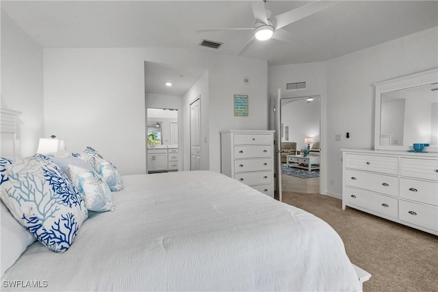 bedroom featuring ceiling fan, visible vents, connected bathroom, and carpet flooring