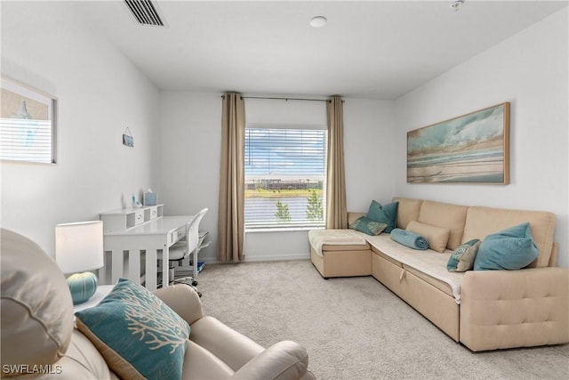 living room with visible vents, carpet flooring, and baseboards