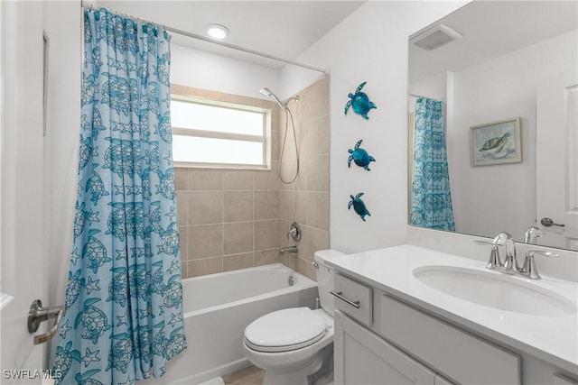 bathroom featuring visible vents, toilet, vanity, and shower / bath combo