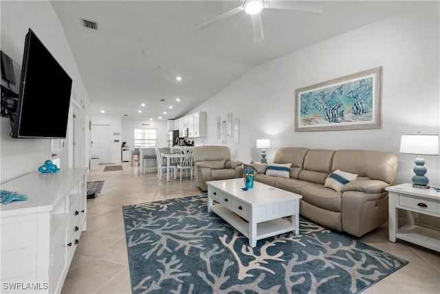 living room with light tile patterned floors, visible vents, ceiling fan, and vaulted ceiling