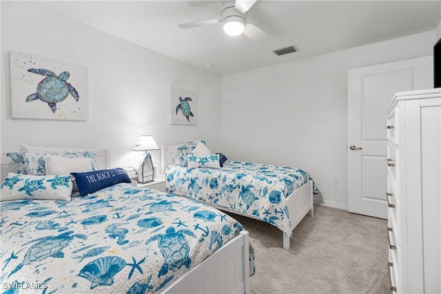 bedroom with visible vents, light carpet, baseboards, and a ceiling fan