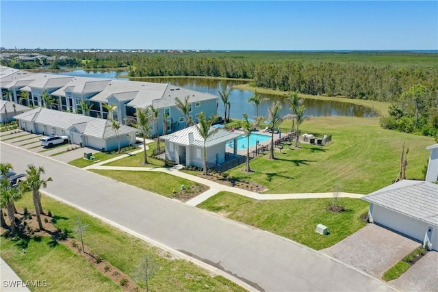 birds eye view of property with a forest view and a water view