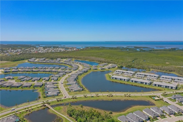 drone / aerial view with a water view and a residential view