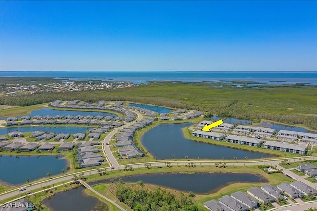 drone / aerial view with a water view and a residential view