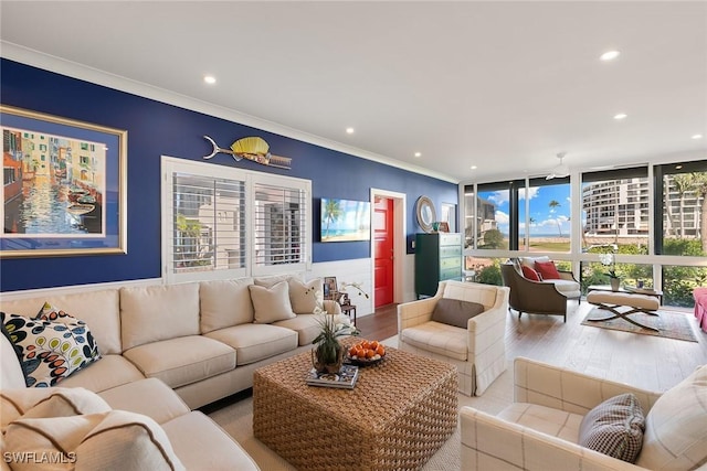 living area featuring ornamental molding, recessed lighting, wood finished floors, and floor to ceiling windows