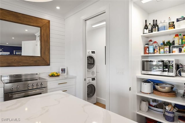 interior space with stacked washer and clothes dryer