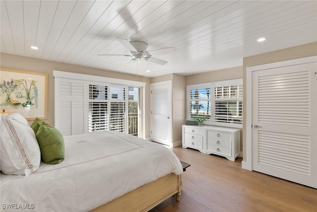 bedroom with a ceiling fan, wood ceiling, light wood-style floors, two closets, and recessed lighting