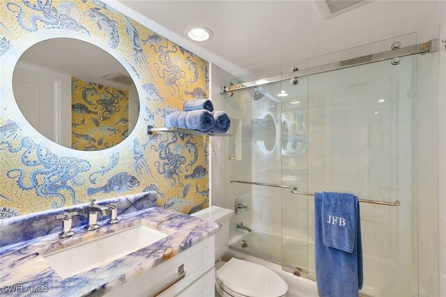 bathroom featuring toilet, vanity, visible vents, and wallpapered walls