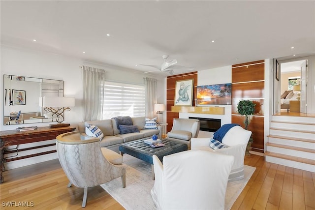 living room featuring recessed lighting, stairway, a glass covered fireplace, ceiling fan, and wood finished floors