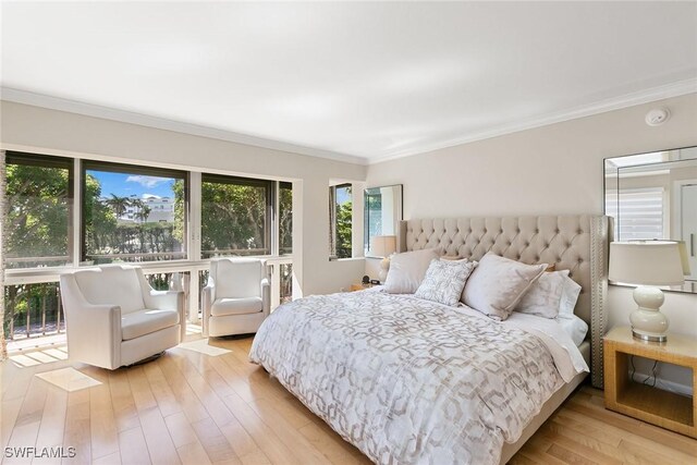 bedroom featuring light wood finished floors and crown molding