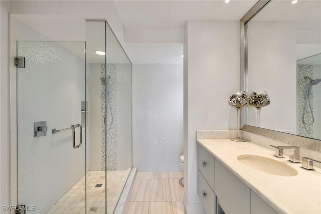 bathroom featuring toilet, a stall shower, recessed lighting, and vanity