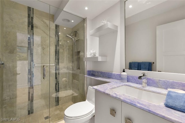 bathroom featuring a stall shower, vanity, toilet, and recessed lighting