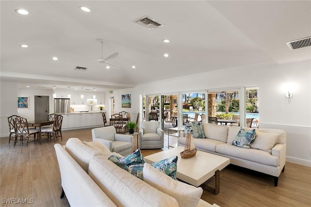 living area featuring recessed lighting, visible vents, and light wood finished floors