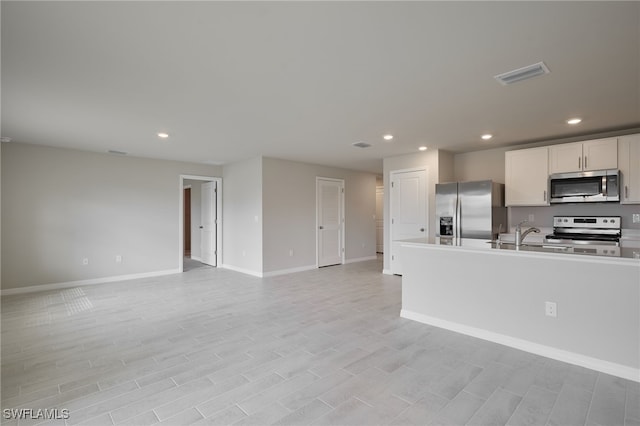 kitchen with open floor plan, visible vents, stainless steel appliances, and recessed lighting