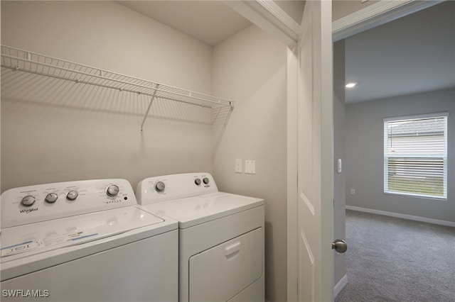 clothes washing area with laundry area, carpet flooring, independent washer and dryer, and baseboards