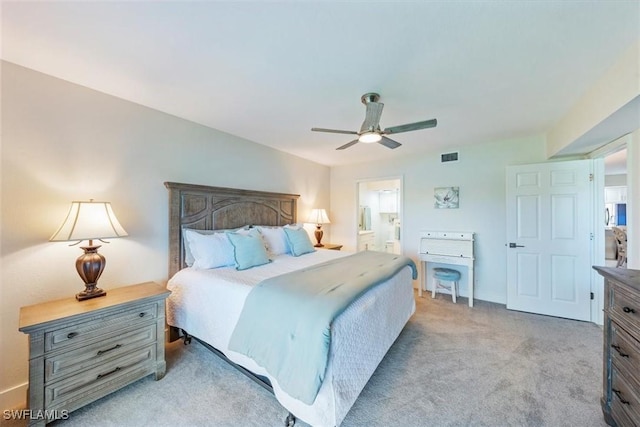bedroom with connected bathroom, light colored carpet, a ceiling fan, baseboards, and visible vents
