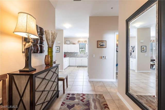 hall with light tile patterned floors and baseboards