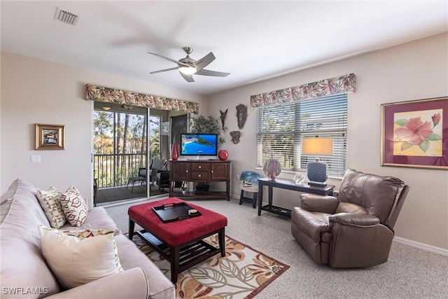 living area with visible vents, baseboards, a ceiling fan, and carpet floors