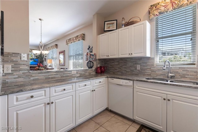 kitchen featuring dishwasher, tasteful backsplash, white cabinetry, and a sink