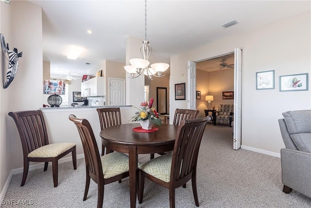 dining space with visible vents, light carpet, baseboards, and a ceiling fan