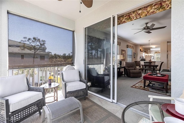 sunroom featuring ceiling fan