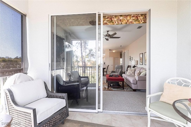 sunroom / solarium featuring visible vents and a ceiling fan