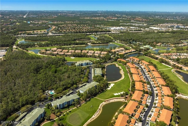 aerial view with golf course view and a water view