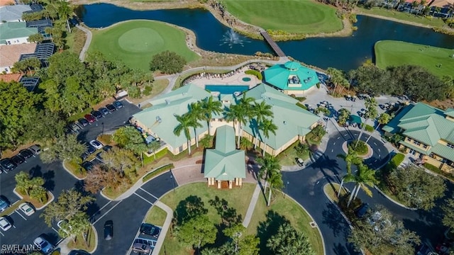 drone / aerial view featuring a residential view, a water view, and view of golf course