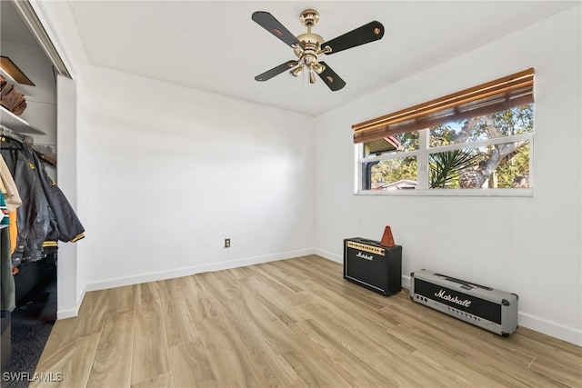 bedroom with light wood-style flooring, baseboards, and ceiling fan