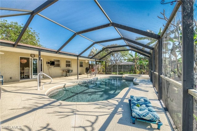 outdoor pool featuring a patio area, a lanai, and fence