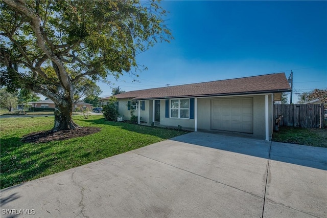 ranch-style home featuring stucco siding, an attached garage, concrete driveway, and a front yard