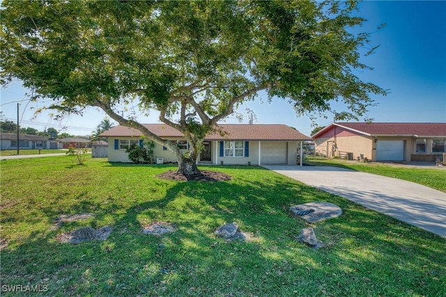 single story home with concrete driveway, an attached garage, and a front lawn