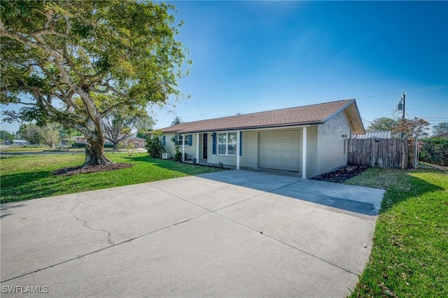 ranch-style house featuring stucco siding, driveway, fence, a front yard, and an attached garage