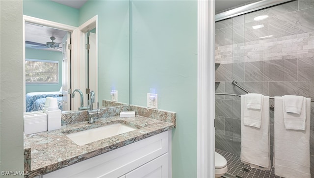 full bathroom with toilet, a stall shower, vanity, and a ceiling fan