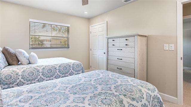 bedroom with a ceiling fan, visible vents, baseboards, and light tile patterned floors