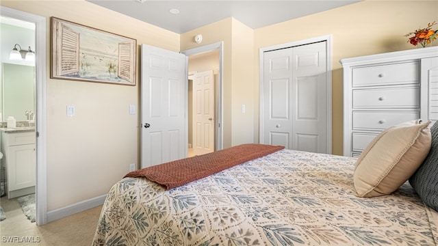 bedroom with baseboards and connected bathroom