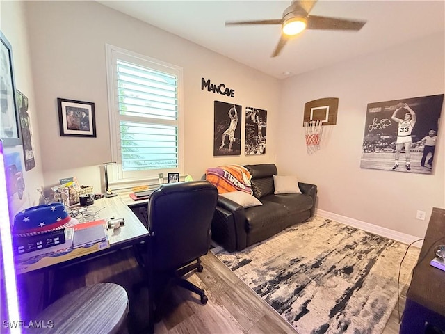 home office featuring baseboards, a ceiling fan, and wood finished floors