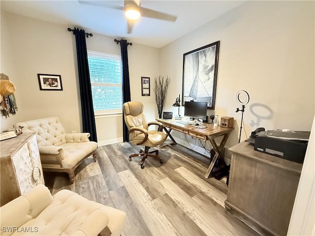 office area with ceiling fan, baseboards, and wood finished floors