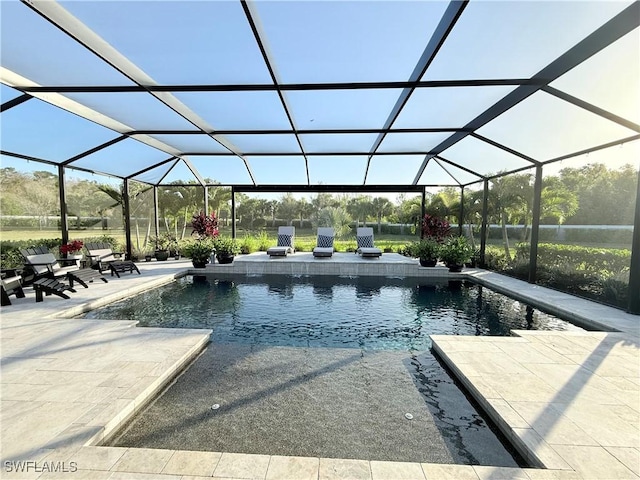 outdoor pool with a lanai and a patio area