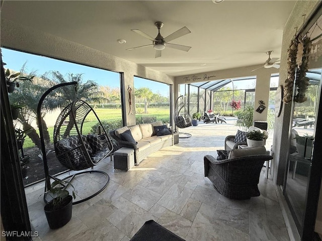 sunroom featuring ceiling fan