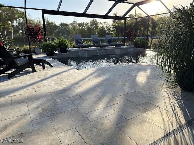 outdoor pool with a patio and glass enclosure