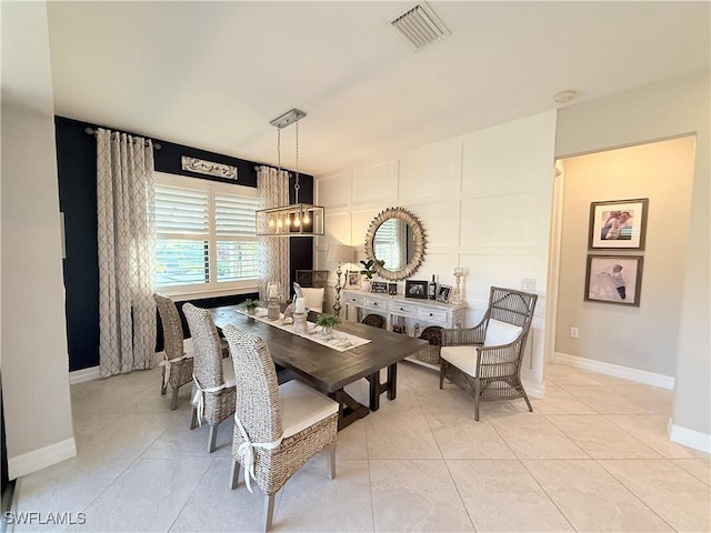 dining space with baseboards, visible vents, and light tile patterned flooring