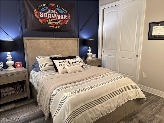 bedroom featuring a closet, wood finished floors, and baseboards