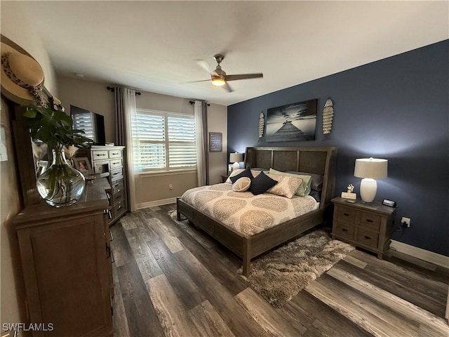 bedroom with a ceiling fan, baseboards, and wood finished floors