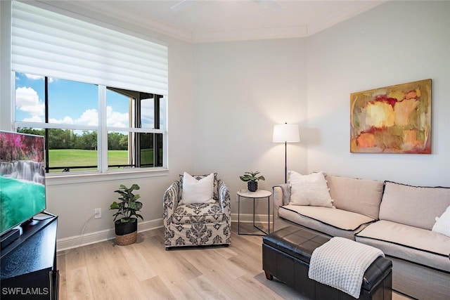 living room with crown molding, wood finished floors, and baseboards