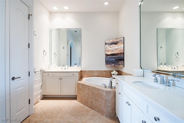 bathroom featuring a bath, recessed lighting, tile patterned floors, and a sink