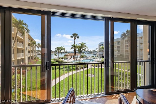 sunroom / solarium featuring a water view