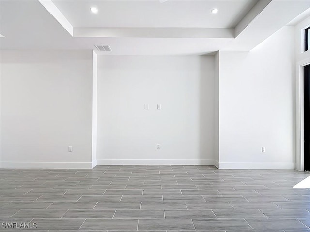 spare room with wood finish floors, recessed lighting, visible vents, and baseboards