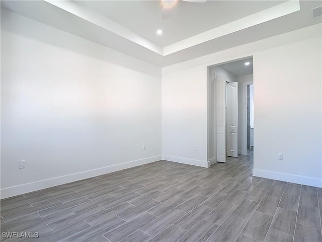 spare room featuring visible vents, baseboards, a ceiling fan, wood finish floors, and recessed lighting